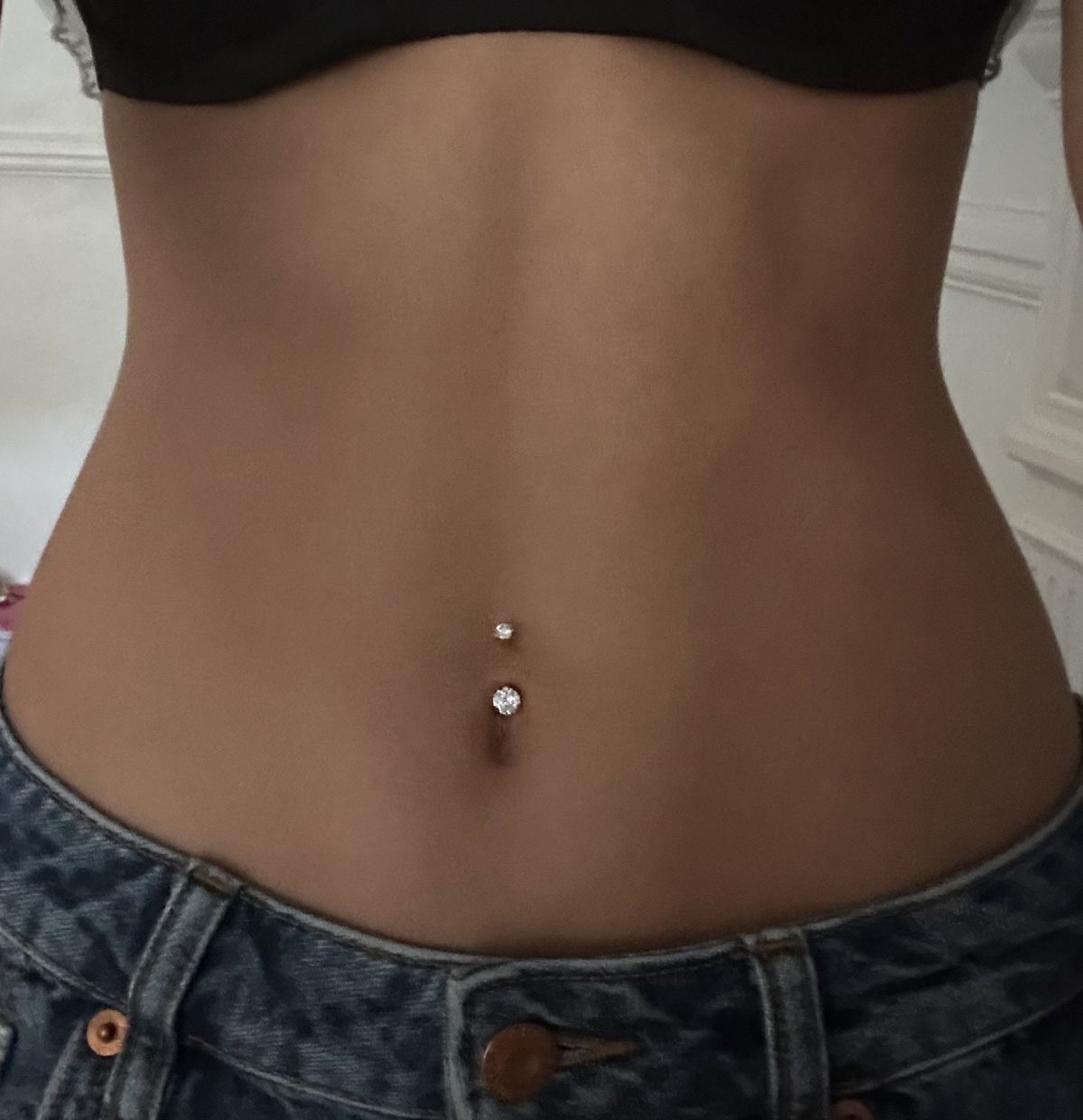 Navel piercing with a two-piece stud