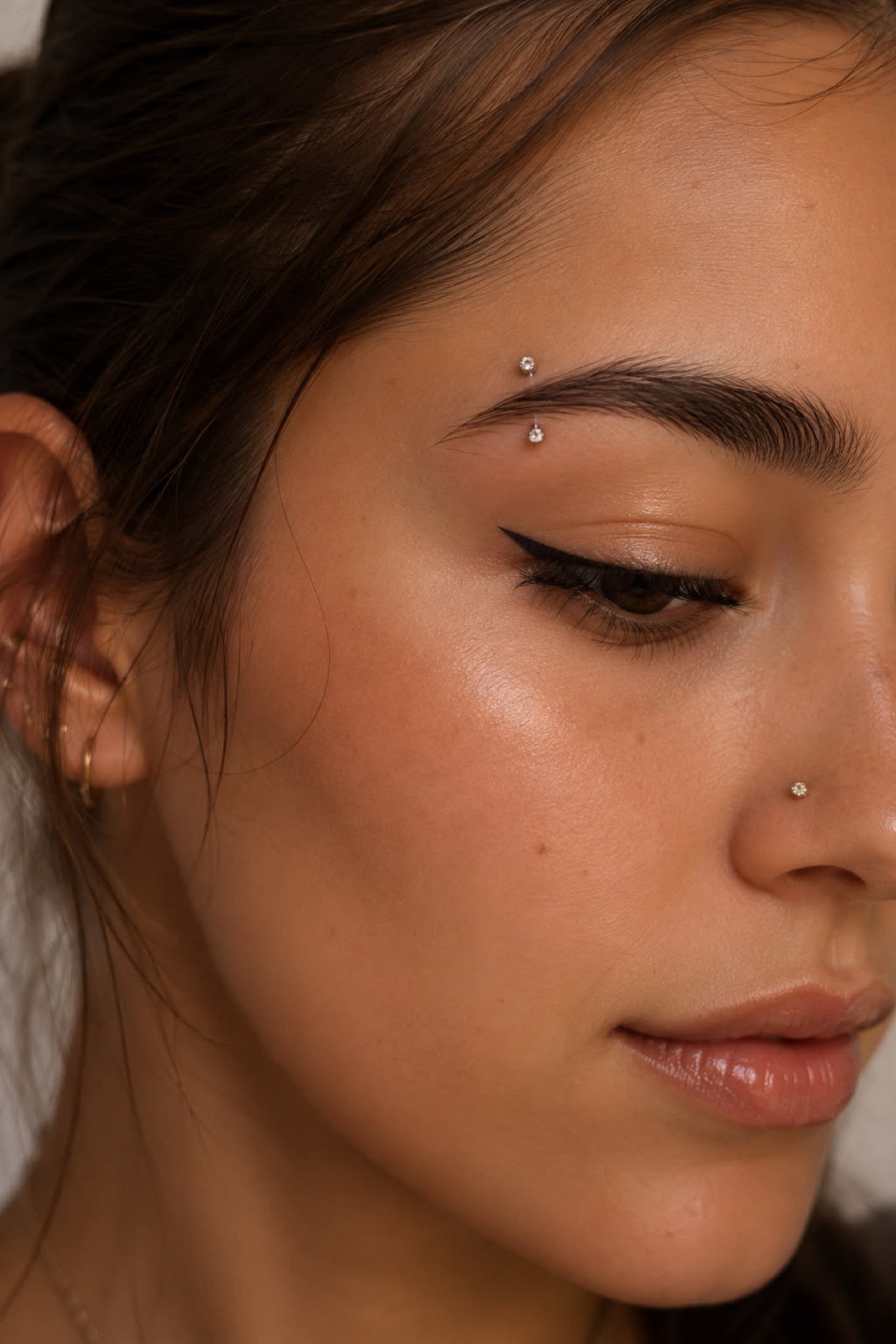 Eyebrow and nostril piercings