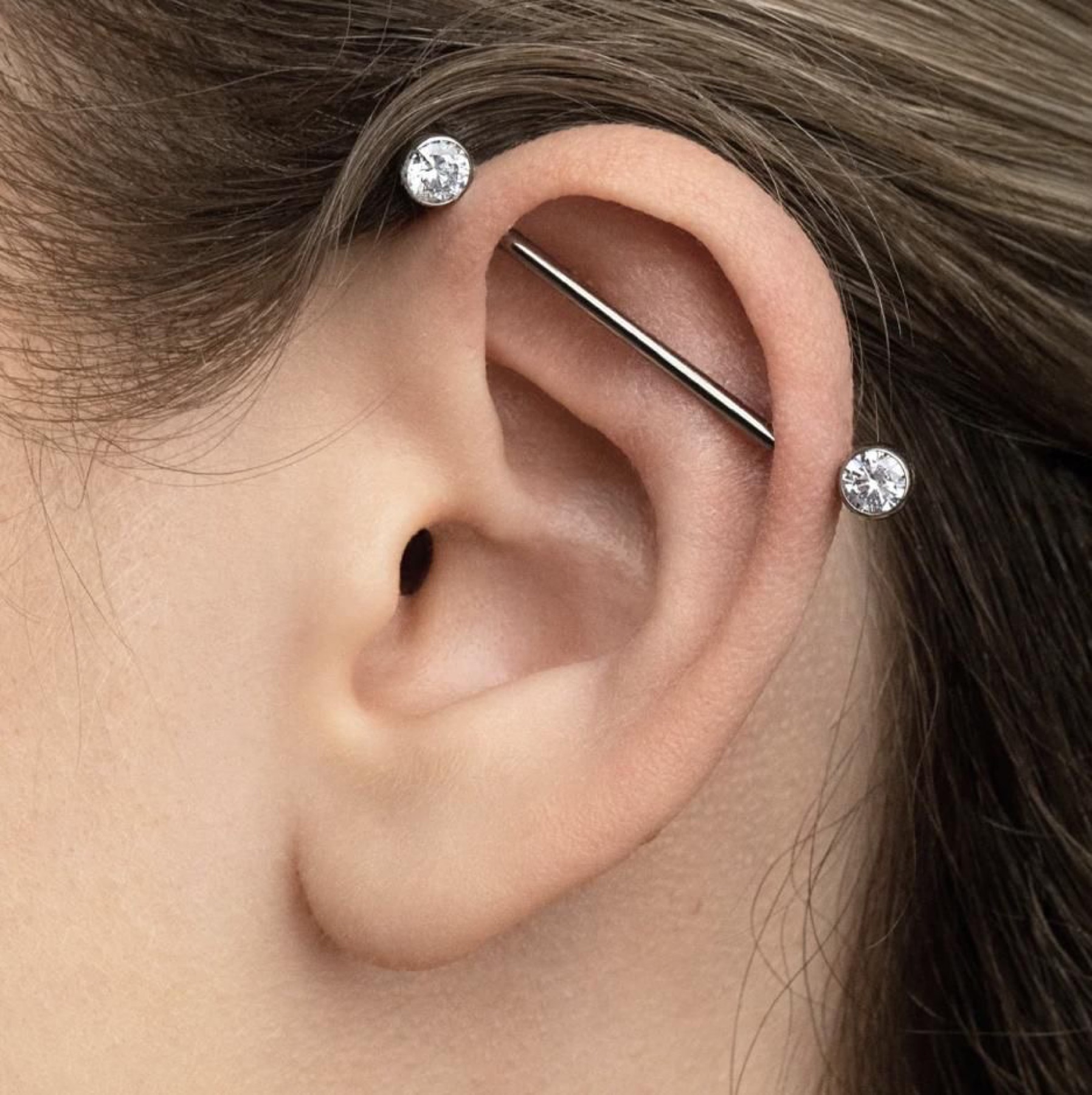 Industrial ear piercing with a straight bar